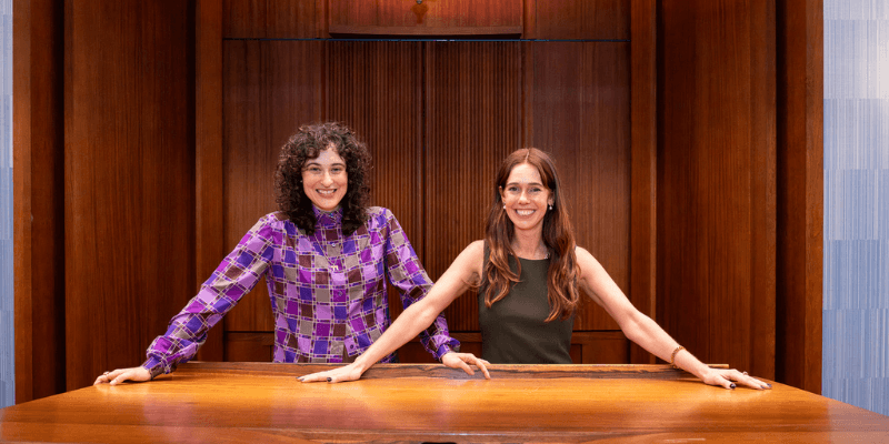 Tami Sussman and Kate Lewis at Shule with arms on the bima