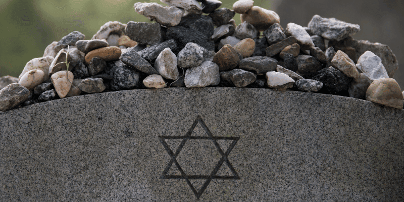 stones on jewish grave with magen david